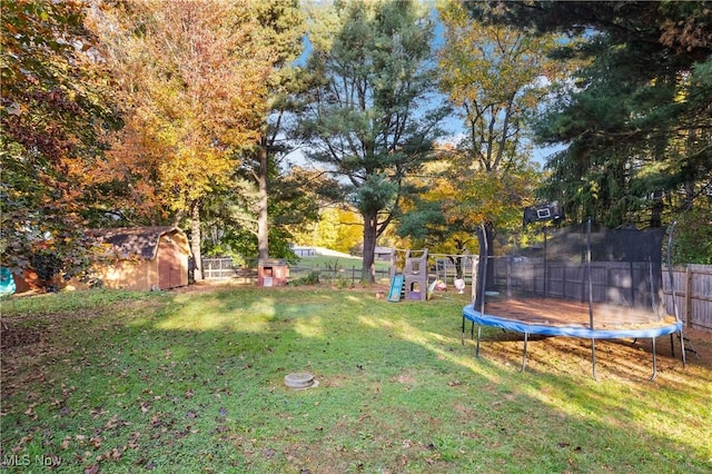 view of yard featuring a playground and a trampoline