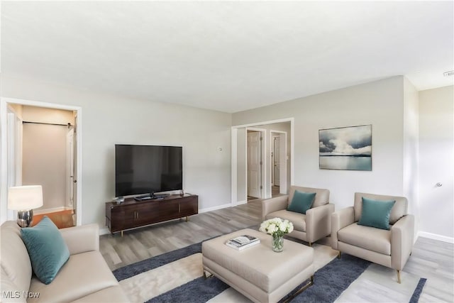 living room with light hardwood / wood-style flooring