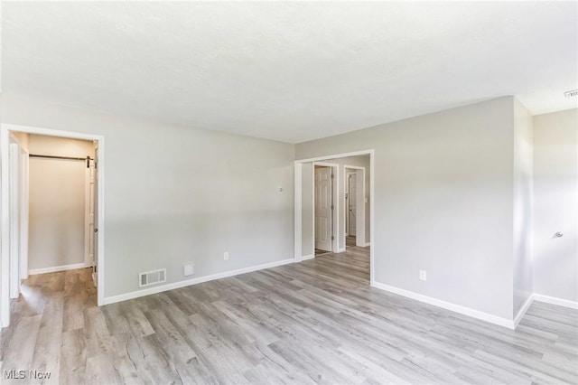 empty room with light wood-type flooring