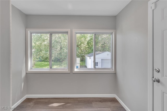 unfurnished room featuring hardwood / wood-style flooring