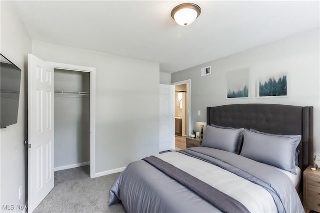 bedroom featuring light colored carpet and a closet