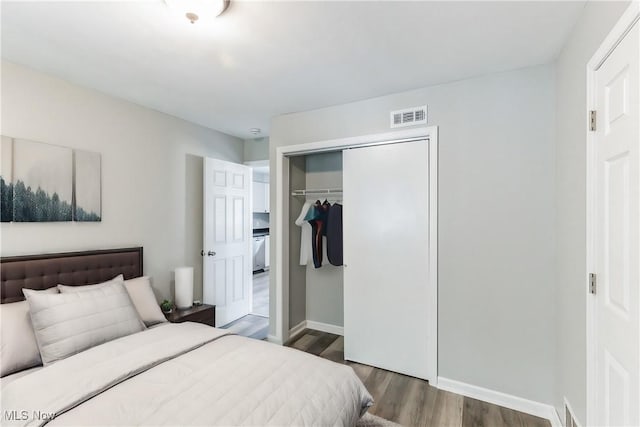 bedroom with a closet and dark hardwood / wood-style floors