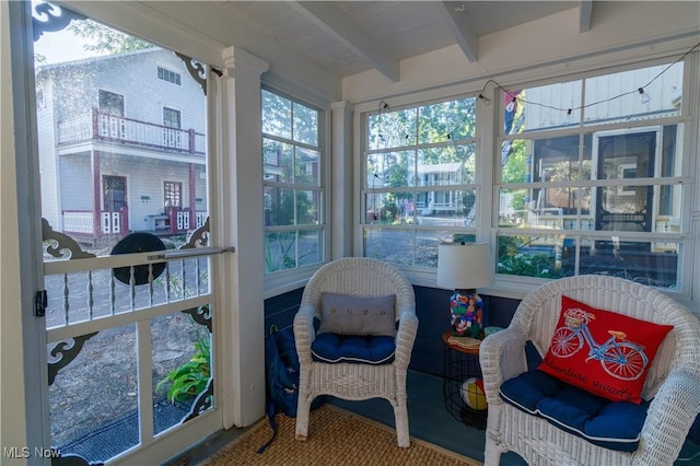 sunroom / solarium featuring beam ceiling and a wealth of natural light