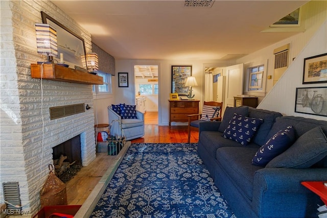 living room with a fireplace and hardwood / wood-style floors