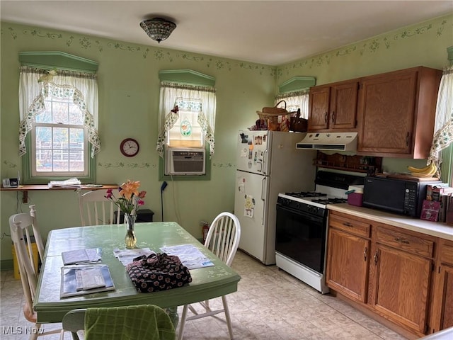 kitchen featuring cooling unit and white range with gas stovetop