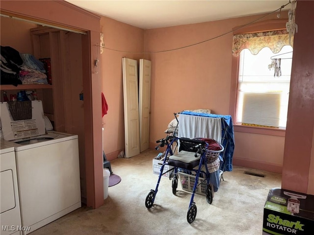 misc room with light carpet and independent washer and dryer