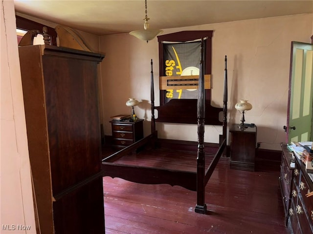 bedroom with dark hardwood / wood-style flooring