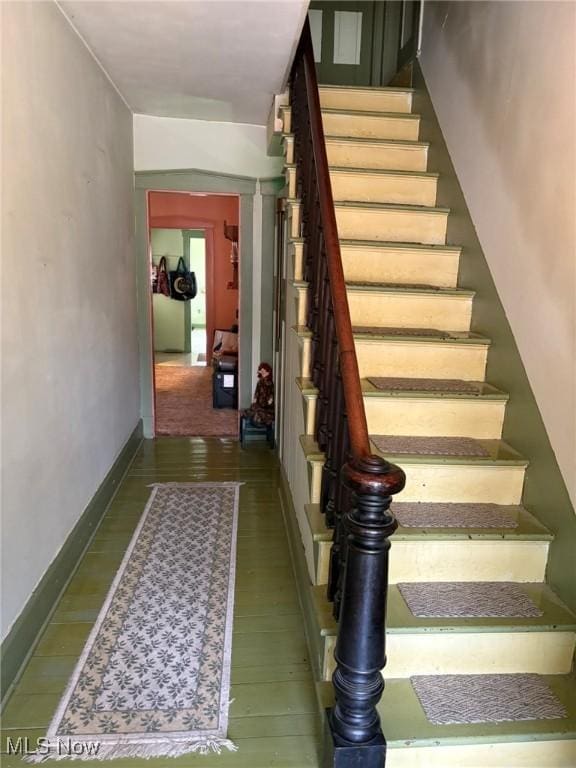 stairs featuring wood-type flooring