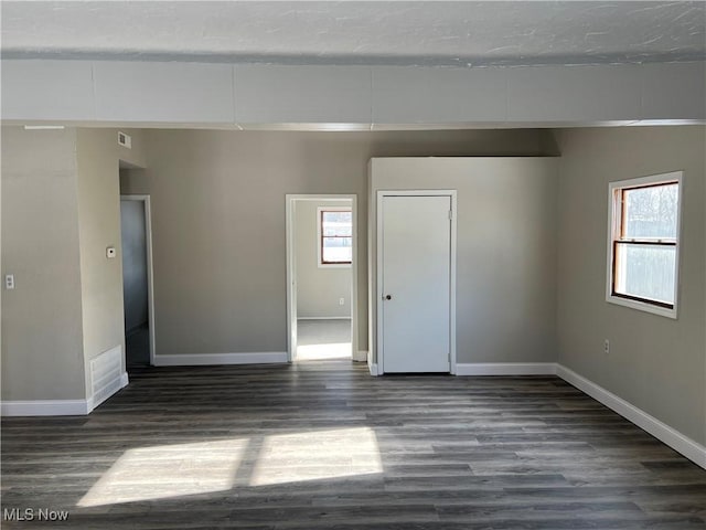 spare room with dark hardwood / wood-style floors