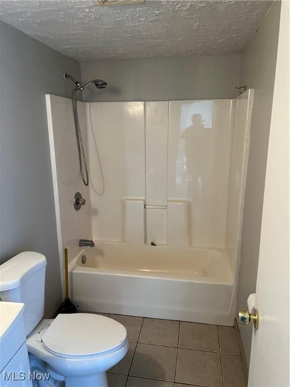 full bathroom featuring tile patterned flooring, vanity, a textured ceiling, and shower / bathing tub combination