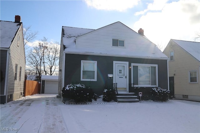 view of front of house featuring a garage and an outdoor structure