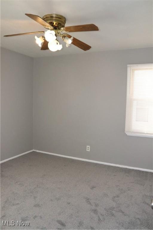 carpeted spare room featuring ceiling fan