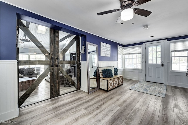 entrance foyer with ceiling fan and light wood-type flooring