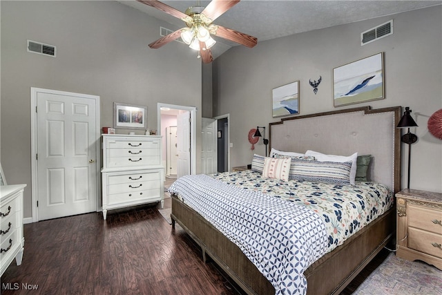 bedroom with connected bathroom, ceiling fan, dark wood-type flooring, high vaulted ceiling, and a textured ceiling