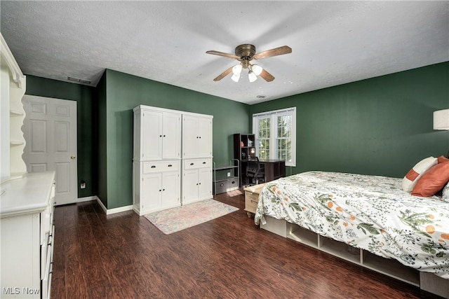 bedroom featuring ceiling fan, dark hardwood / wood-style flooring, and a textured ceiling