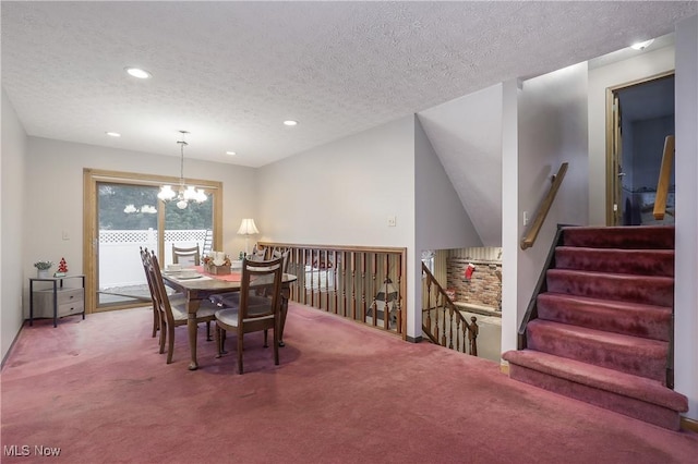 carpeted dining area with a textured ceiling and a notable chandelier