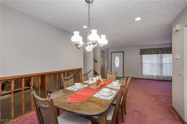 dining space with dark carpet, a textured ceiling, and a chandelier