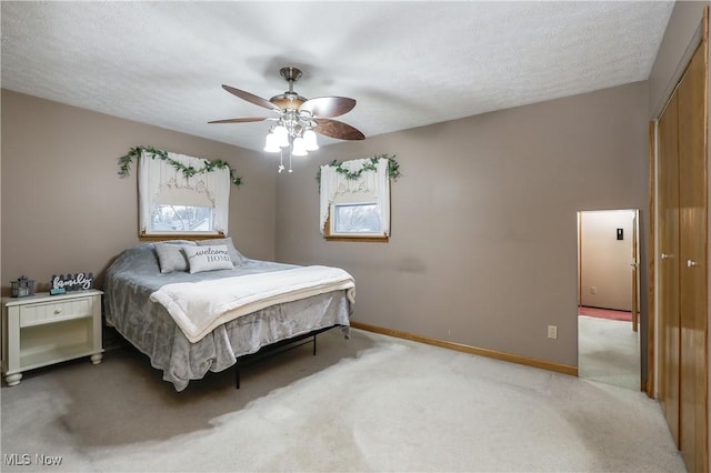 carpeted bedroom with ceiling fan and a closet