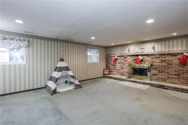 game room featuring light carpet and a textured ceiling