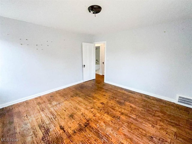 spare room with dark wood-type flooring