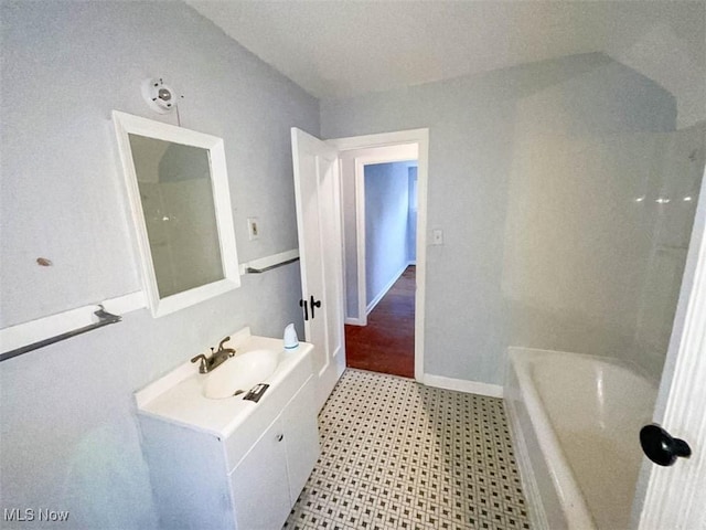 bathroom with vanity and a tub to relax in