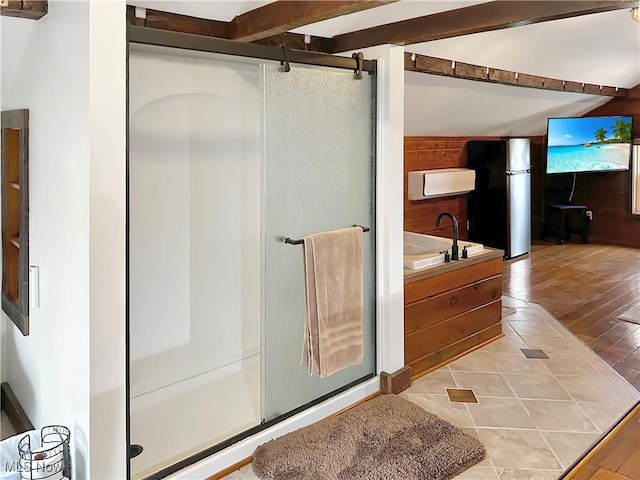 bathroom featuring hardwood / wood-style flooring, sink, and plus walk in shower