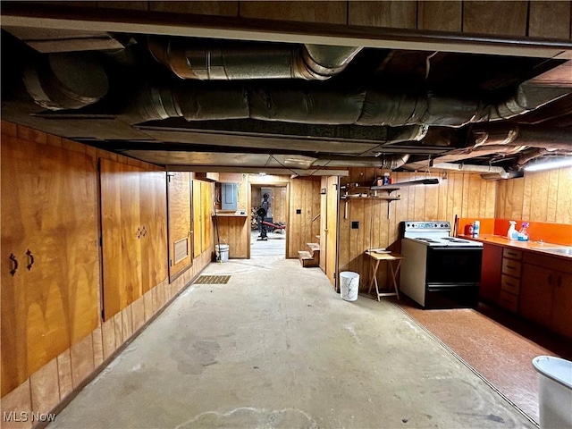 basement featuring wooden walls