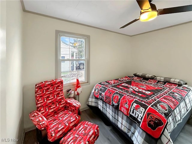 bedroom with ceiling fan and dark wood-type flooring