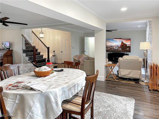 dining space with crown molding, ceiling fan, and dark wood-type flooring