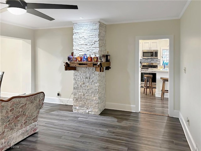 interior space with white cabinets, stainless steel appliances, dark hardwood / wood-style floors, and ornamental molding