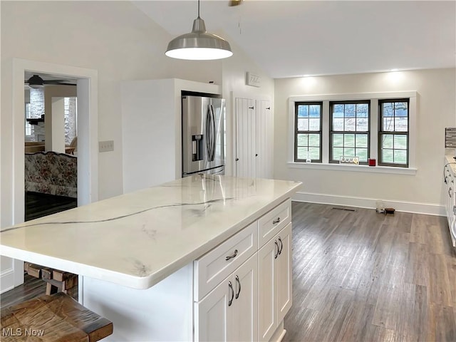 kitchen with stainless steel fridge, decorative light fixtures, a center island, dark hardwood / wood-style floors, and white cabinetry