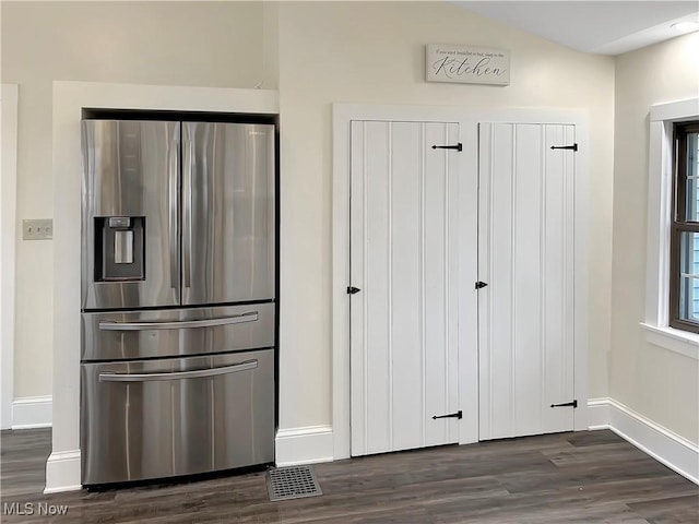 kitchen featuring stainless steel fridge and dark hardwood / wood-style floors