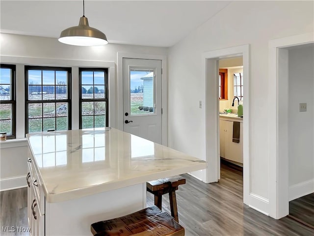 dining area with vaulted ceiling and dark wood-type flooring