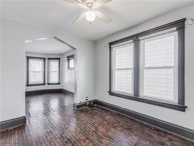 unfurnished room featuring dark hardwood / wood-style flooring and ceiling fan