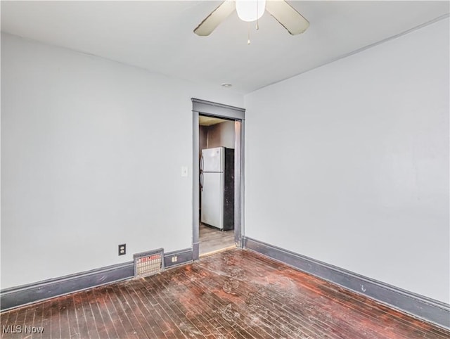 spare room with hardwood / wood-style flooring and ceiling fan