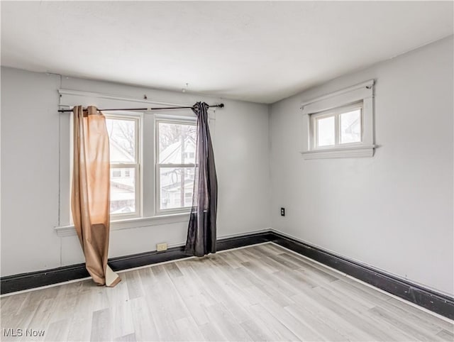 spare room with light wood-type flooring