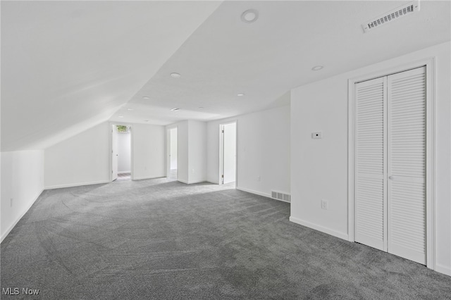 additional living space featuring carpet and lofted ceiling