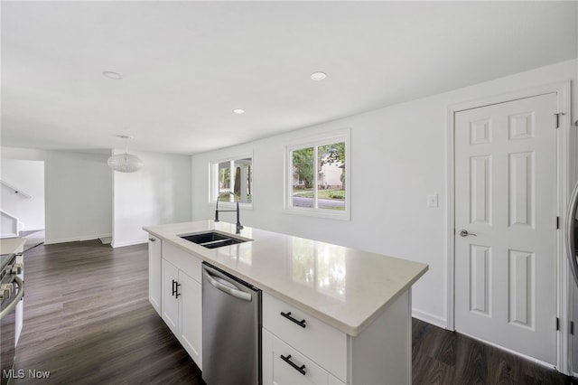 kitchen featuring appliances with stainless steel finishes, dark hardwood / wood-style flooring, sink, white cabinetry, and an island with sink