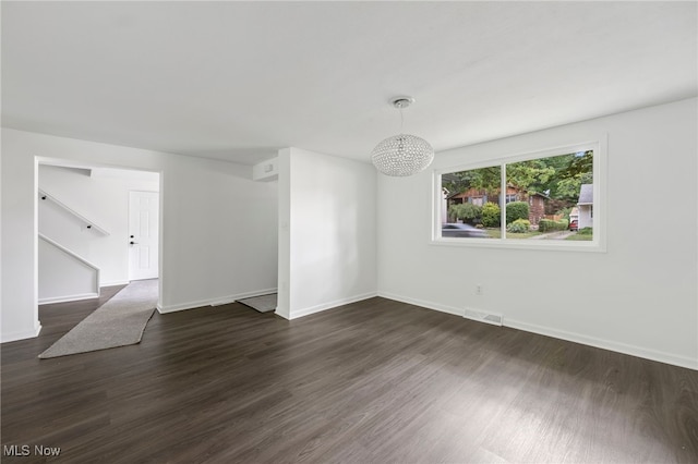 empty room with dark hardwood / wood-style flooring