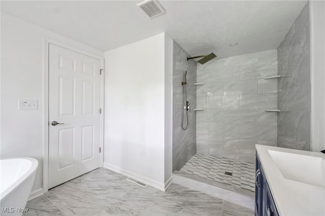 bathroom with vanity, independent shower and bath, and a textured ceiling