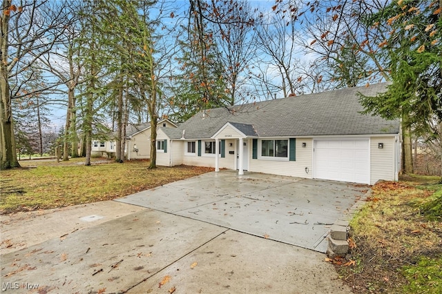 single story home featuring a garage and a front yard