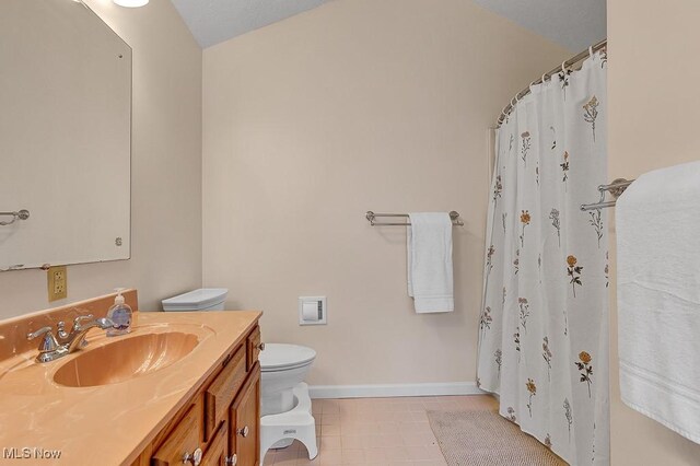 bathroom with tile patterned flooring, vanity, curtained shower, and toilet