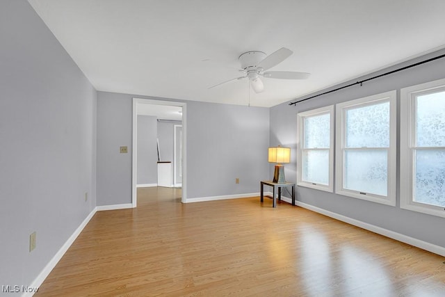 spare room featuring ceiling fan and light hardwood / wood-style floors