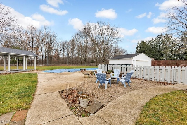 exterior space with a patio area, a yard, an outbuilding, and a garage