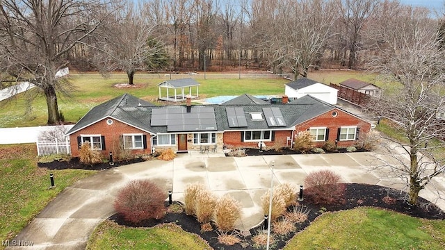 exterior space with a front lawn and solar panels