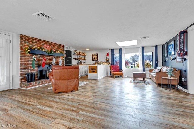 living room with light wood-type flooring and a wood stove