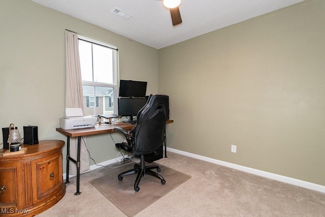 carpeted office space featuring ceiling fan