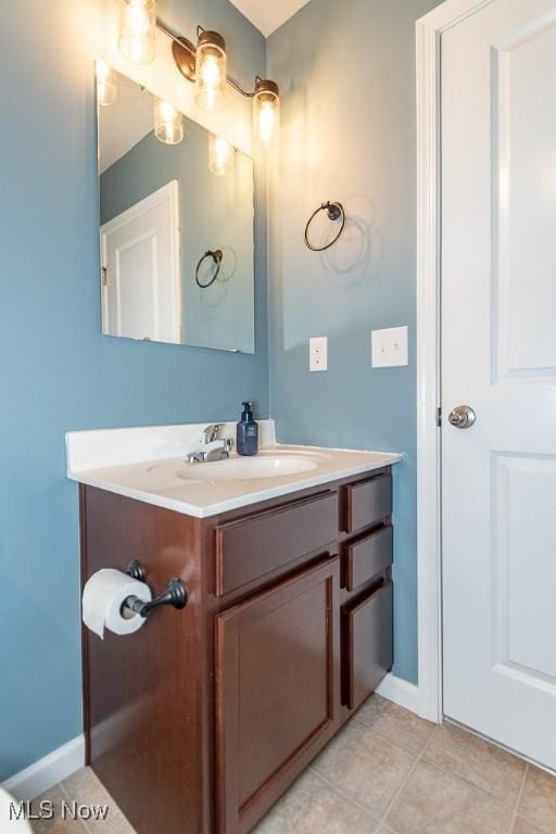 bathroom with tile patterned flooring and vanity