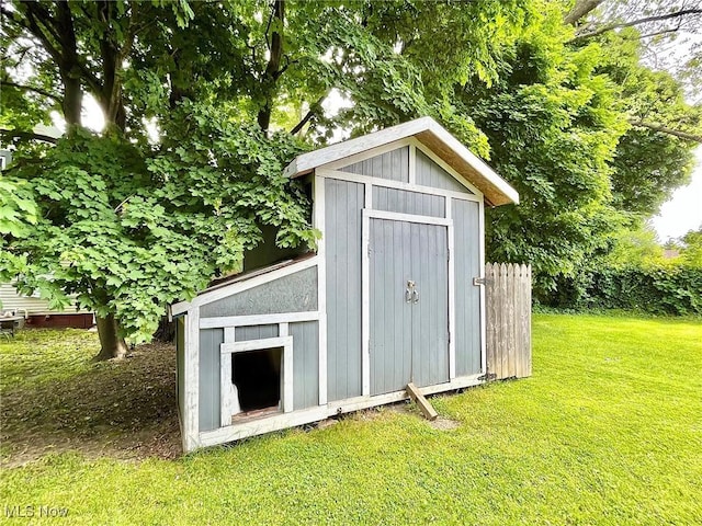 view of outbuilding featuring a yard