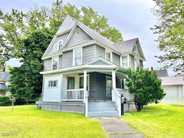 view of front of house featuring covered porch and a front yard